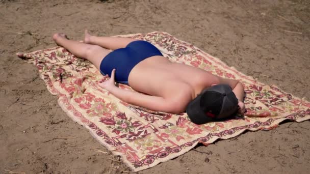 Boy Sunbathing Lying Sleeping Beach Coverlet Sand Sun Back View — Stock Video