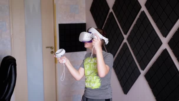 Teenager Glasses Game Controllers Plays Soundproof Room Boy White Helmet — Stock Video