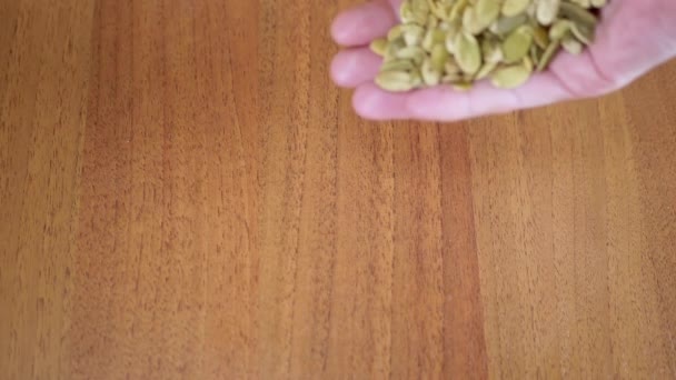 Lot Raw Pumpkin Seeds Fall Female Hands Table Thrown Green — Stock Video