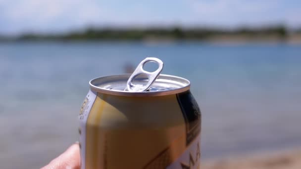 Female Hand Holding Open Tin Beer Can Blurred Backdrop River — Stock video