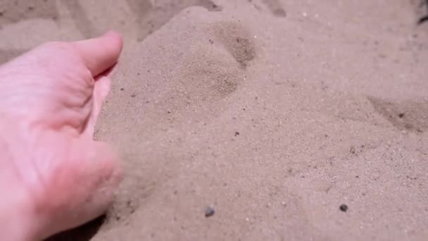 Female Hand Pours Sand Fingers Beach Rays Sunlight Fine Grains — 图库视频影像
