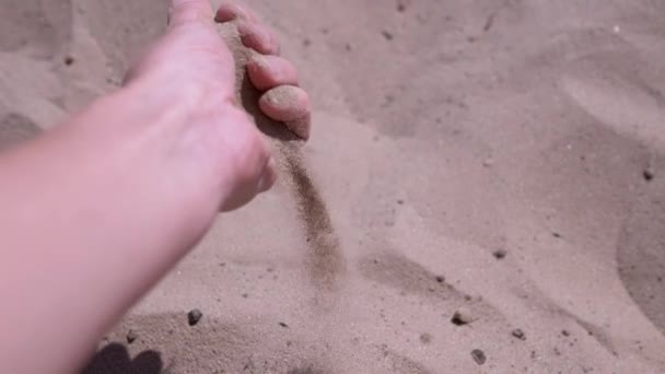 Female Hand Pours Sand Fingers Beach Rays Sunlight Fine Grains — ストック動画