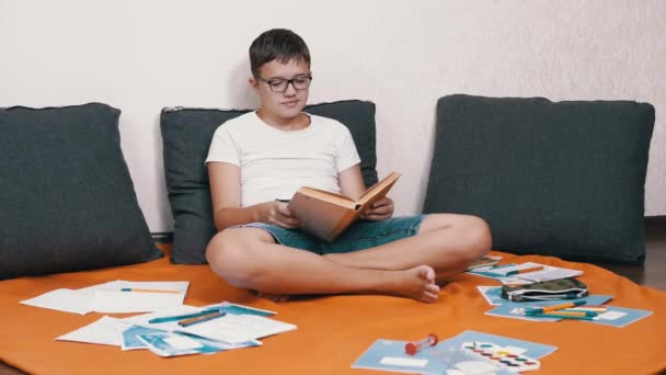 Smart Child Glasses Reading Interesting Book Sitting Floor Room Smiling — Stockvideo