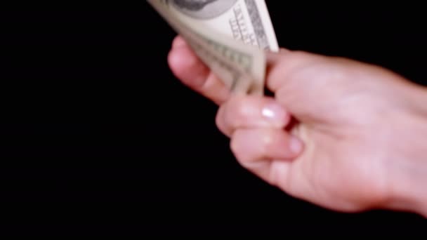 Hand Holding Three 100 Dollar Bills Isolated Black Background Concept — Αρχείο Βίντεο
