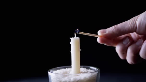 Hand Lights White Wax Candle Using Match Black Background Bright — Stockvideo