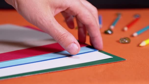 Female Hands Laying Multicolored Sheets Cardboard Orange Background Preparation Colored — Vídeos de Stock