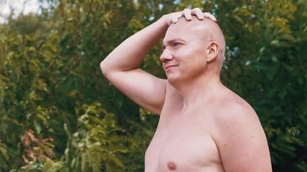 Pensive Bald Male Thinks Dreams Nature Stroking Head Hand Outdoors — Stock Video