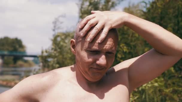 Pensive Bald Male Thinks Dreams Nature Stroking Head Hand Outdoors — Stock Video