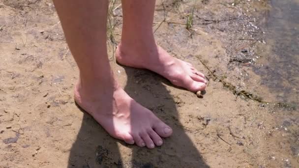 Male Tanned Legs Standing Wet Sand Water Rays Sunlight Nature — Stockvideo