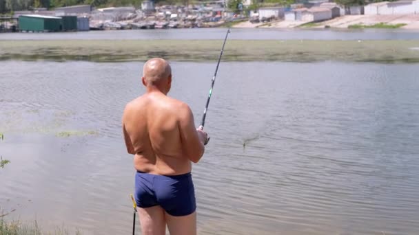 Happy Fisherman Pulls Caught Fish Out Water Using Fishing Rod — Αρχείο Βίντεο