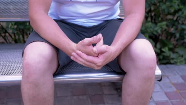 Male Rubbing Hands Sitting Bench Urban Park Moment Waiting Excitement — 图库视频影像