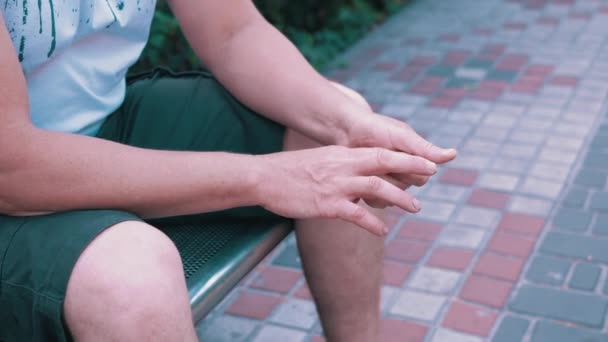 Male Rubbing Hands Sitting Bench Urban Park Moment Waiting Excitement — Stockvideo