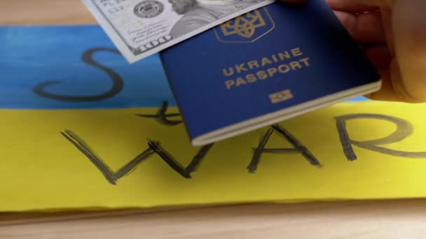 Hand Legt Einen Biometrischen Reisepass Der Ukraine Mit Bargeld Auf — Stockvideo