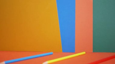 Renkli Kağıt ve Karton 'un Parlak Doymuş Çok Renkli Arkaplanı. Yeşil, turuncu mavi, sarı renkler, kalemler. Renkleri öğrenmek, anaokulu çocukları için şekiller. Gökkuşağı. - Okul. Eğitim.