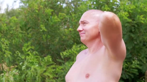 Pensive Bald Male Thinks Dreams Nature Stroking Head Hand Outdoors — Stock video