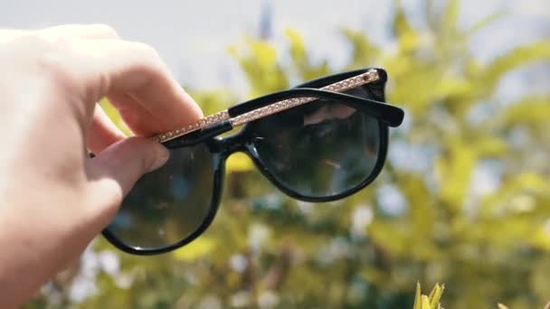 Female Hand Stretches Dark Sunglasses Backdrop Nature Girl Enjoying Relaxing — Αρχείο Βίντεο