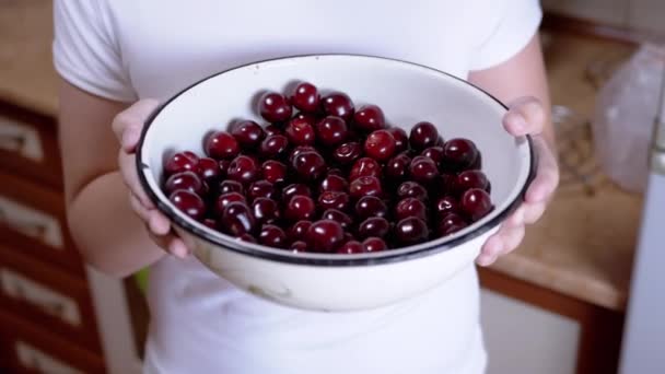 Child Holding Full Bowl Red Cherries Hands While Standing Kitchen — Αρχείο Βίντεο