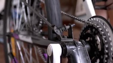 Close-up Rotation of a Bicycle Wheel, Pedals, Chain. Six-speed gearbox. Master checks transport before the trip. Movement of gear on a chain. Bicycle repair at home. Test, restoration, mending.