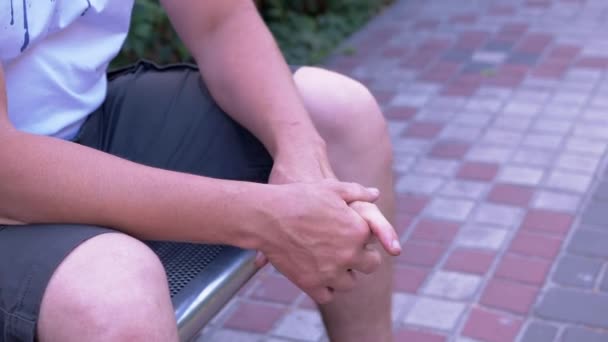 Male Rubbing Hands Sitting Bench Urban Park Moment Waiting Excitement — 비디오