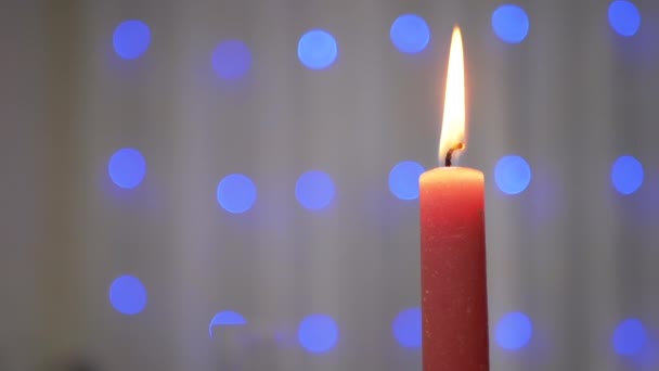 Christmas Red Candle Burning Blurred Background Flickering Garland Bright Blue — Stock Video