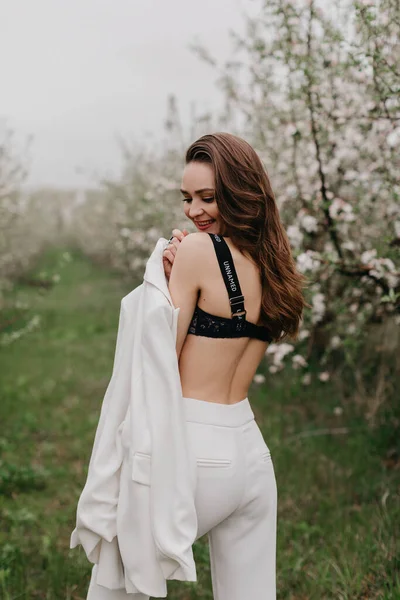 Gorgeous model  posing in spring garden with blossom