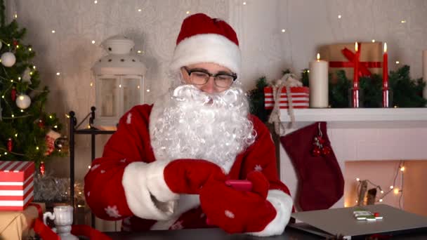 Der Weihnachtsmann scrollt Feed, schaut Videos in den sozialen Medien und lacht in Zeitlupe — Stockvideo