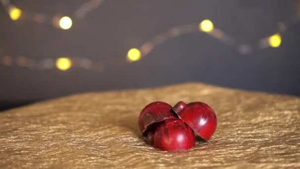 Los caramelos de chocolate rojo giran en círculo. Fondo de guirnalda de Navidad. — Vídeo de stock