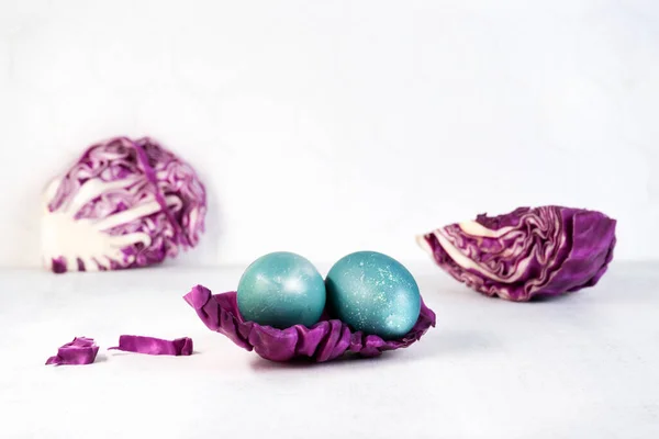 Coloración natural Huevos de Pascua en color azul con hojas de col roja. —  Fotos de Stock