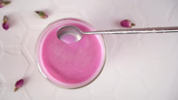 粉红玫瑰牛奶。用勺子搅拌热牛奶.一杯月球牛奶。健康饮料 — 图库视频影像