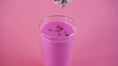 Pembe gül sütü. Bir bardak ay sütüne gül yaprakları ekliyorum. Sağlıklı içecek..