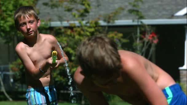 Two Young Boys Having Squirt Gun Fight Slow Motion Shot — Stock Video