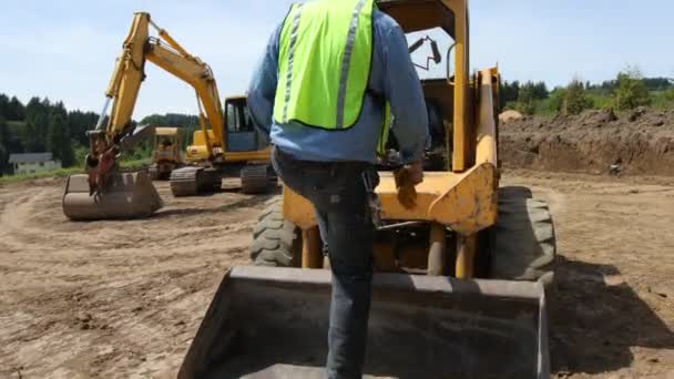 Worker Climbs Skid Steer Excavator — Stock Video