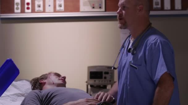 Emergency Room Doctors Examine Man Head Injury — Stock Video