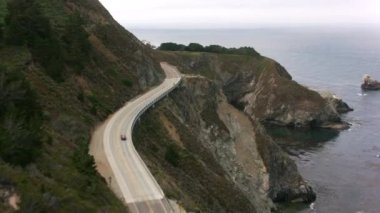 Kaliforniya - 2017 dolaylarında Kaliforniya 'daki Big Sur Sahili boyunca Bixby Creek Köprüsü' ne doğru esiyor. Cineflex ve RED Epic-W Helyum ile çekilmiştir..