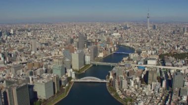 Tokyo, Japonya 2018 dolaylarında. Tokyo Skytree ile Sumida Nehri üzerinde uçuyor. Kırmızı kamerayla helikopterden çekilmiş..
