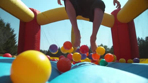 Boy Bouncing Inflatable Play House Super Slow Motion — Stock Video