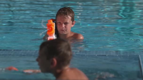 Boys Having Squirt Gun Fight Pool Super Slow Motion — Stock Video