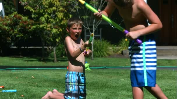 Two Young Boys Having Squirt Gun Fight Slow Motion Shot — Stock Video