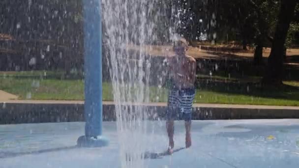 Boy Jumping Water Fountain Summer Day Slow Motion — Stock Video
