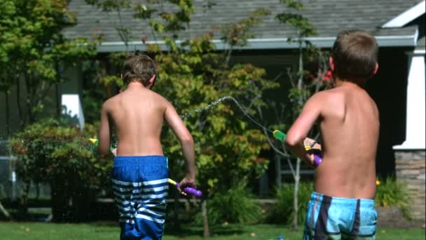 Two Young Boys Having Squirt Gun Fight Slow Motion Shot — Stock Video