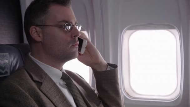 Forretningsmann Som Snakker Mobiltelefon Fly – stockvideo