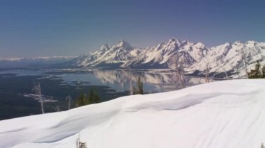 Grand Teton Ulusal Parkı, Rocky Dağları, Wyoming. Güzel kar manzaralı dağ tepeleri ve Jackson Gölü. Helikopterden Shotover gimbal ve RED 8K kamera ile çekildi..