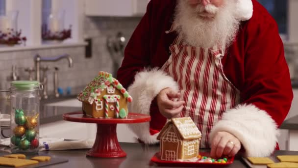 圣诞老公公在厨房装修姜饼屋 — 图库视频影像