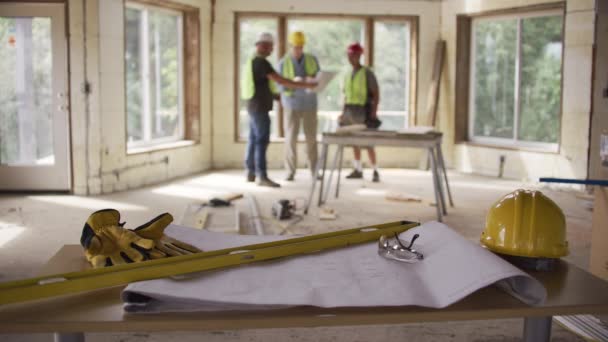 Three Construction Workers Looking Blueprints Background Foreground Focus — Stock Video