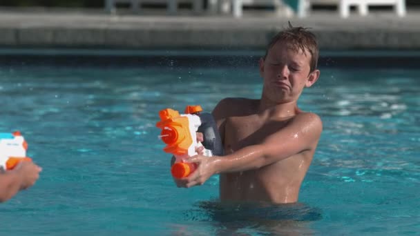 Boys Having Squirt Gun Fight Pool Super Slow Motion — Stock Video