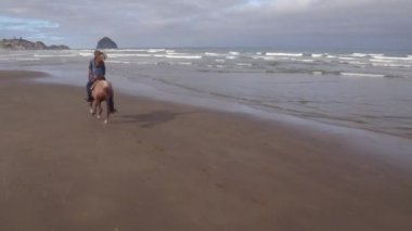 Kumsalda ata binen kadınların hava manzarası.