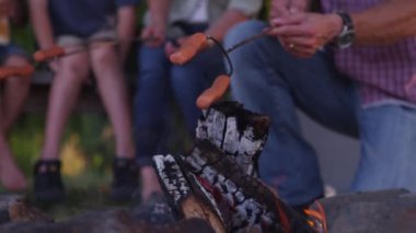 Sosisli sandviç kamp ateşi üzerinde kavurma aile