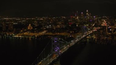 Philadelphia, Pennsylvania 2017 dolaylarında Ben Franklin köprüsü ile Philadelphia 'ya gece yaklaşımı. Cineflex ve RED Epic-W Helyum ile çekilmiştir..