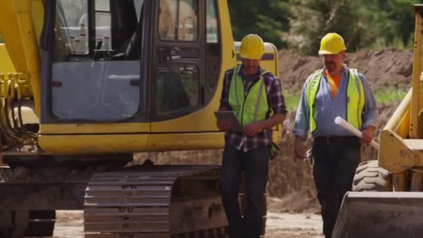 Two Workers Excavation Equipment Look Blueprints — Stock Video