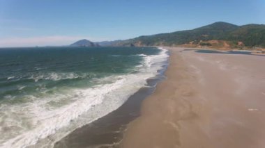 Güzel sahil ve deniz manzarasının üstünde doğa manzarası var. 